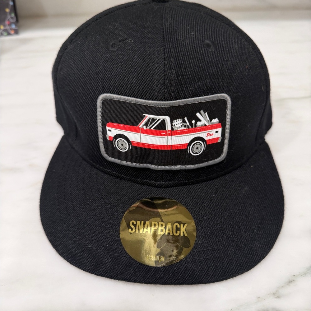 Black Snapback Hat with Red Truck Patch from Baseballism.